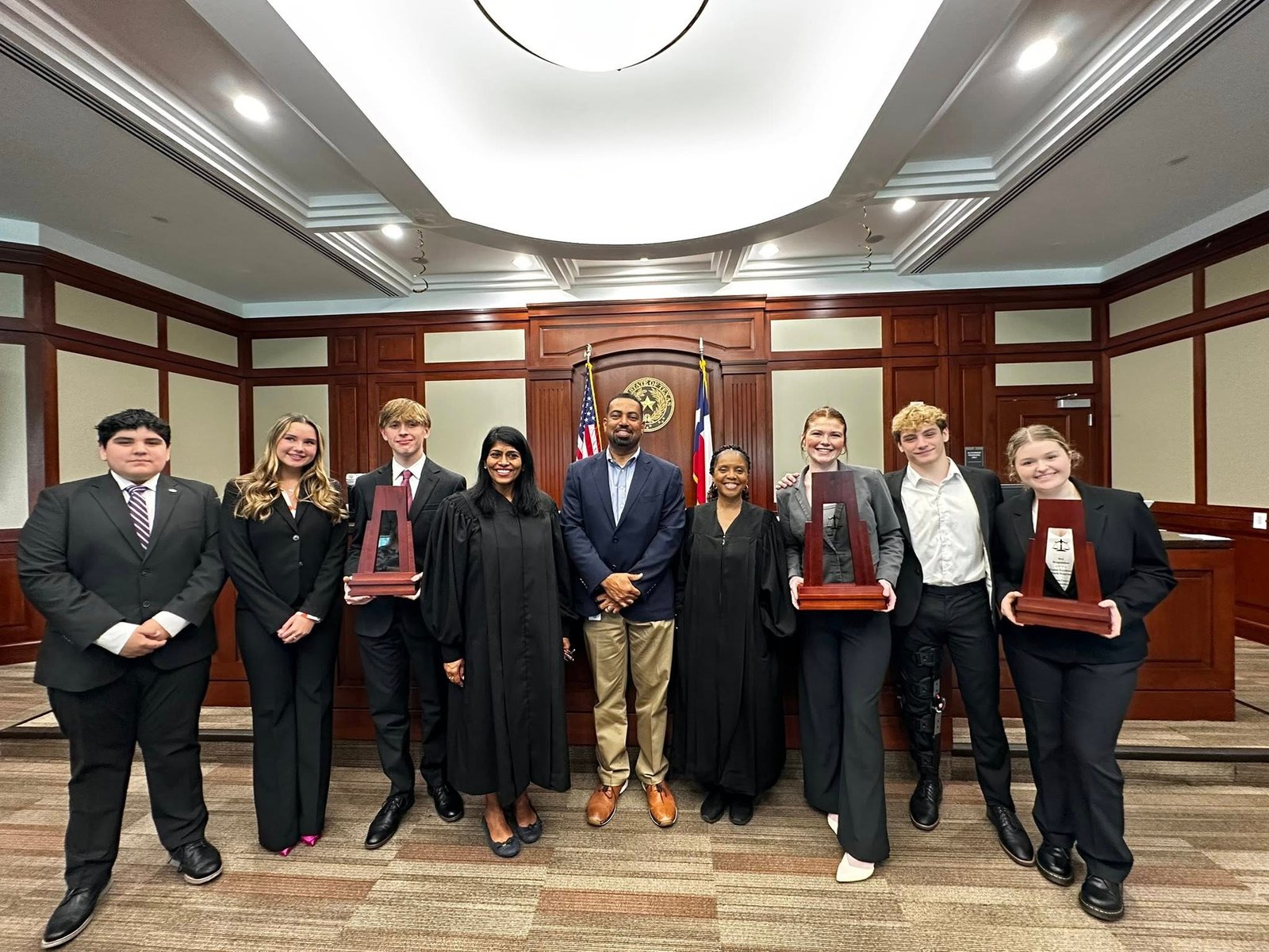 Judge Juli Mathew with high-school mock-trial students in her Fort Bend County courtroom